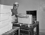 Gary Grunder cutting the rind from a block of Swiss cheese.</p></h5>